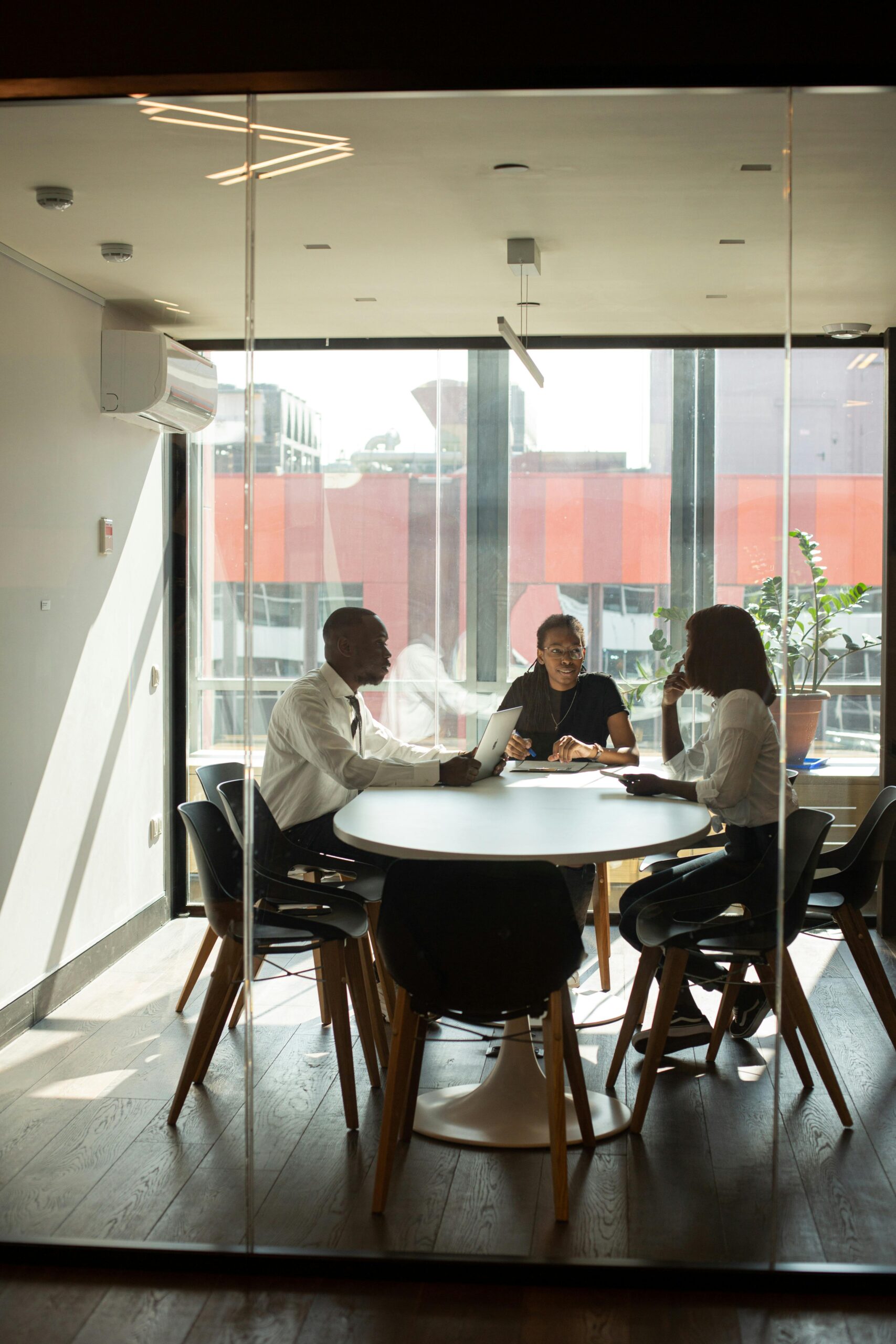 three business people sitting around a conference room table